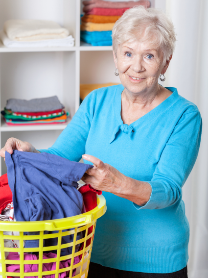 Older adult woman sorting laundry