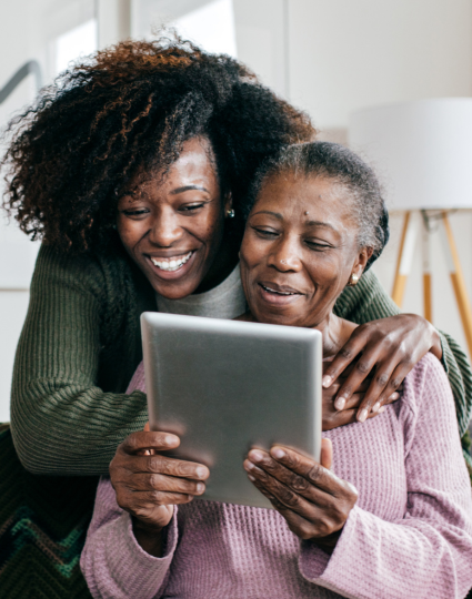 Adult Daughter Helping Older Adult Mom with her tablet