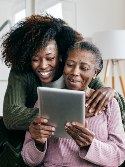 Adult Daughter Helping Older Adult Mom with her tablet